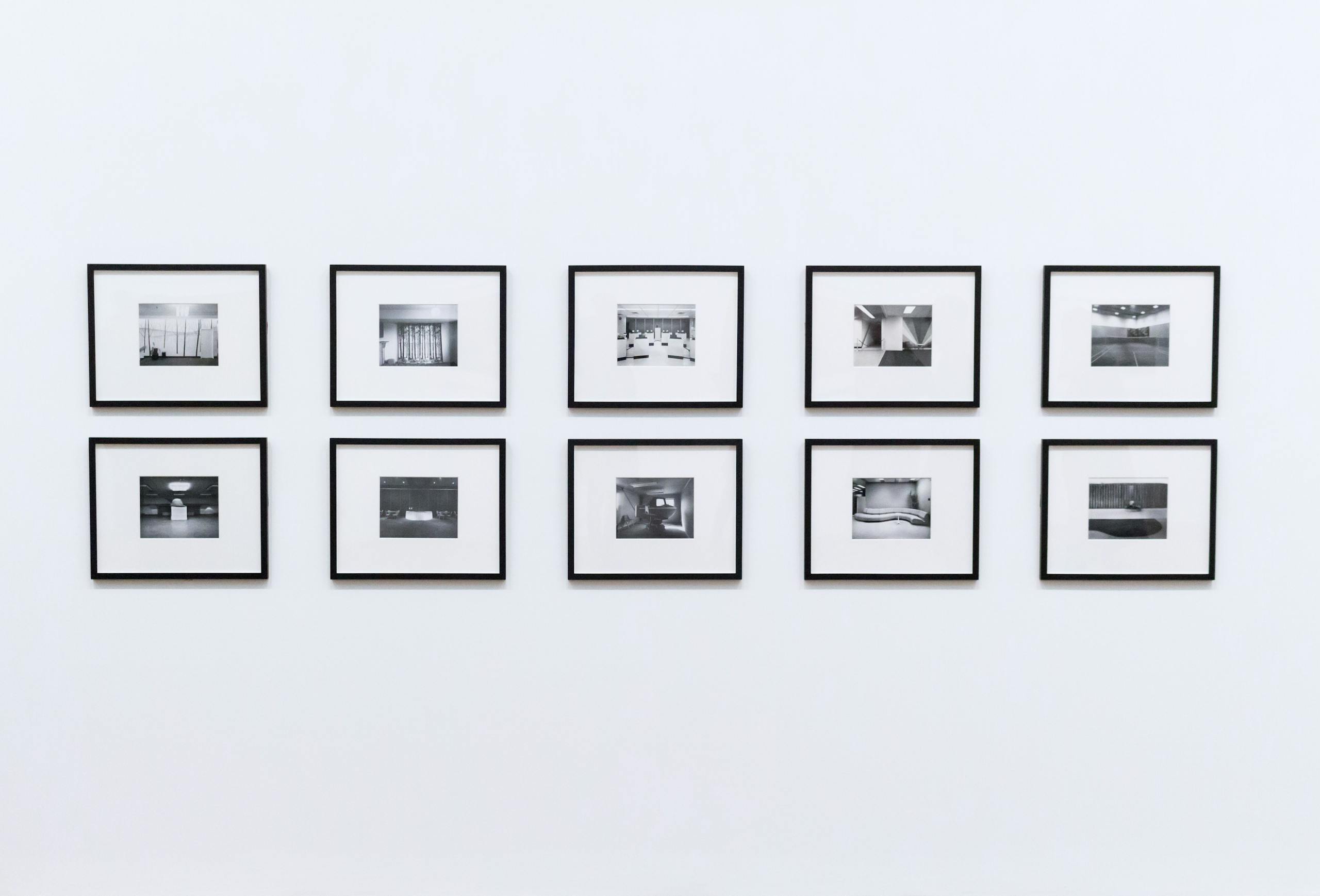 Simple and elegant wall display with black and white framed photographs in a modern interior.